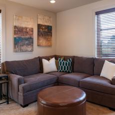 Comfy Living Area Features Plush Brown Sofa, Leather Ottoman & Nesting Side Table