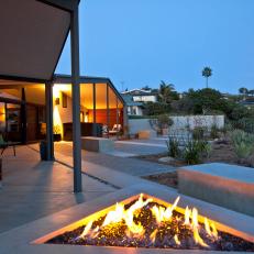 Porch Outside Modern Home Featuring Triangular Fire Pit