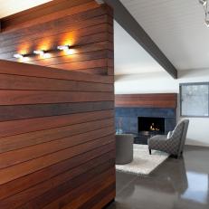 White, Modern Living Area with Wood Block Walls and Limestone Fireplace Surround