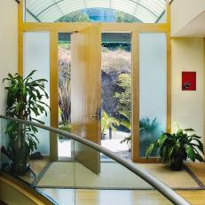 Modern Entryway With Curved Ceiling and Custom Door