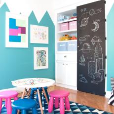 Contemporary Playroom Features Kids Table, Graphic Blue Rug & Chalkboard Door
