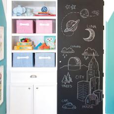 Children's Playroom Features White Shelving & Chalkboard Paint Door