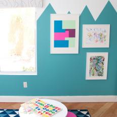 Teal Playroom Features Kid's Artwork, Small Table & Stools