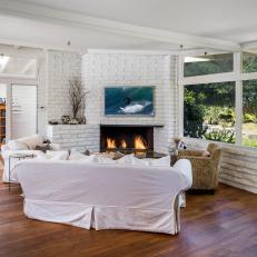 Living Room With Large Windows, Hardwood Floors & Fireplace