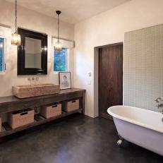 Bathroom Features Clawfoot Tub and Glass Tile Wall