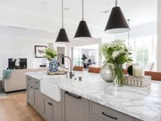 Gray Kitchen Island With White Marble Countertop and Farmhouse Sink