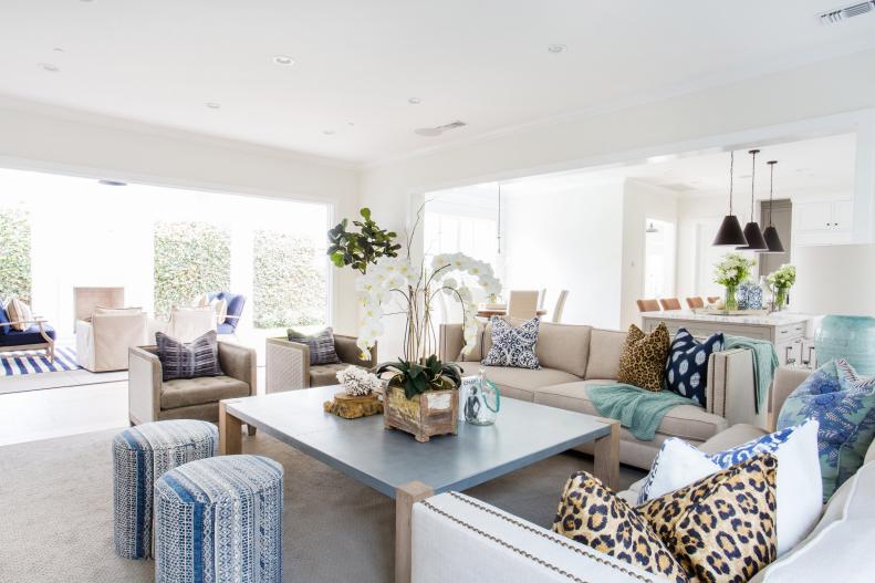 White Living Room With Beige Sofa and Blue Stools