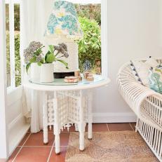 White End Table With Fabric-Covered Lamp and Knick-Knacks