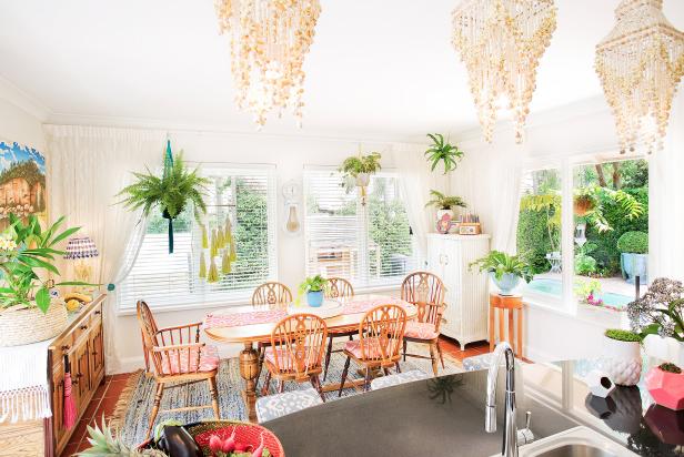 White Dining Space With Woven Area Rug, Large Windows and Chandeliers