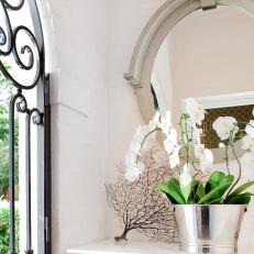 Living Space With Silver Art Deco Mirror, Iron Gate & Orchids