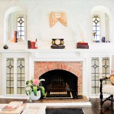 Bright Living Area With Traditional Fireplace & Arched Windows