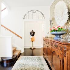 White Hall Boasts Patterned Accent Wall and Wood Sideboard