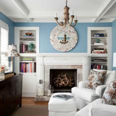 Elegant Small Blue Living Room With White Built in Book Shelves and Fireplace 