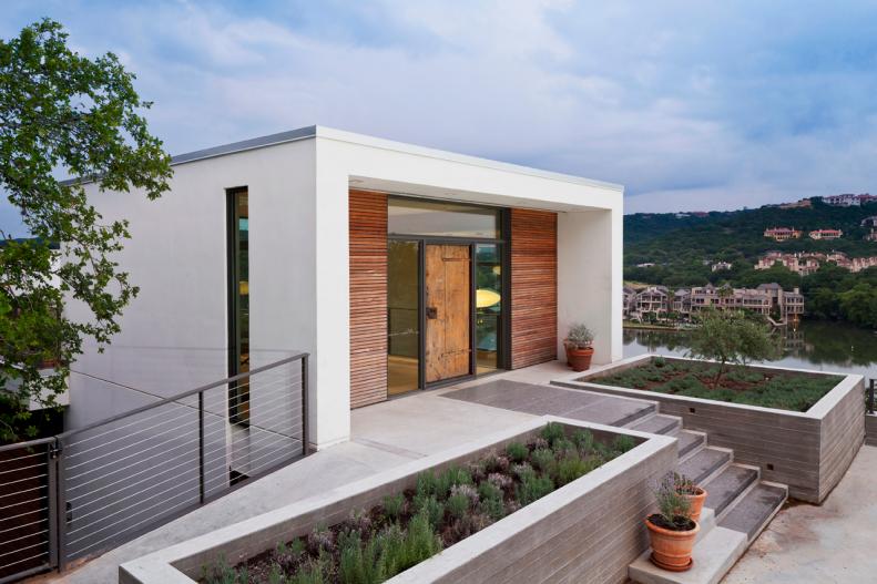 Contemporary White Home Exterior With Wood Front Door
