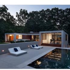 Modern Pool at Night With White Lounge Chairs