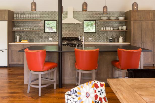 Farmhouse-Inspired Kitchen With Wood Cabinets and Orange Barstools