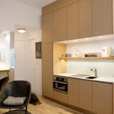 Compact Kitchen Doubles as Base for Lofted Bed in NYC Apartment