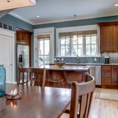 Blue and Brown Open Plan Transitional Kitchen and Dining Area