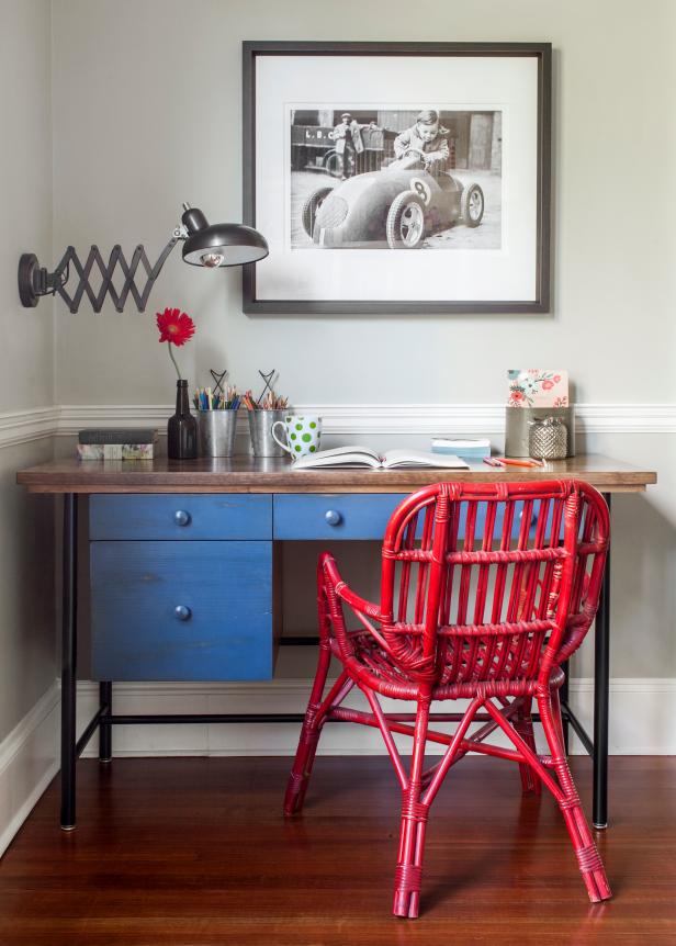 Home Office With Blue Desk, Red Chair and Framed Black and White Photo