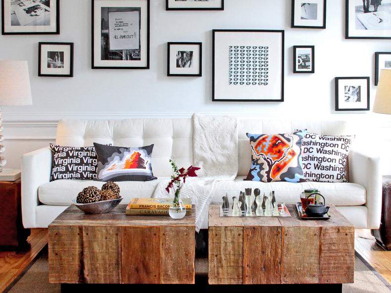 In this contemporary living room, a display of black and white art by Cartoloji draws the eye up. But a pair of reclaimed barnwood coffee tables from Dwelling Home in Philadelphia plays an important role in the light space, providing a grounding center and adding rich texture to the otherwise sleek and simple design.