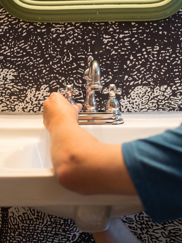 Make sure sink where new faucet will be mounted is clean and free from debris, old caulk, etc. that might prevent a nice, tight fit.  Insert new faucet into sink holes.  On the underside of faucet, put locknuts and washers on the inlet shanks and finger-tighten in place.