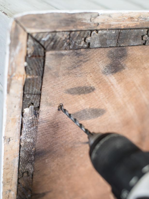 Using an electric drill equipped with a bit the same size as screws, drill pilot holes at each pencil mark.  This is an important step when working with old wood, even if self-boring wood screws are being used.  Old wood may split if a pilot hole is not drilled prior to inserting a screw.
