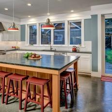 Contemporary Kitchen With Spacious Island and Red Barstools