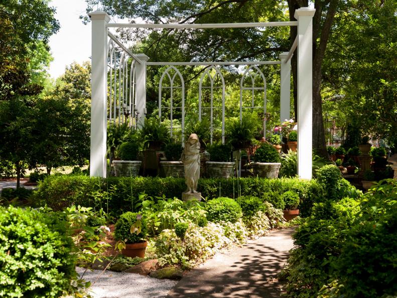 Elegant Garden with Sculpture and Church Windows