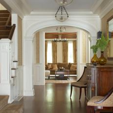 Entryway With Arched Doorway & Rich Wood Flooring