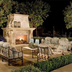 Cozy Patio With Stone Fireplace & Cushioned Furnishings