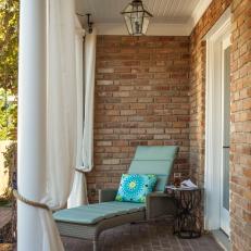 Charming Brick Porch Offers Comfy Lounge Chair