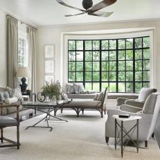 Contemporary Living Room with Large Bay Window and Gray Upholstered Furniture