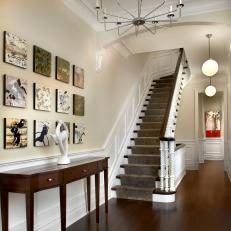 Stylish Foyer With Square Wall Art & Carpeted Staircase