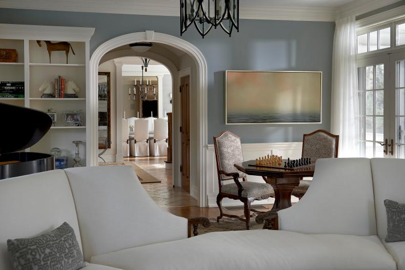 Traditional Blue-Gray Living Room With White Sectional and Game Table