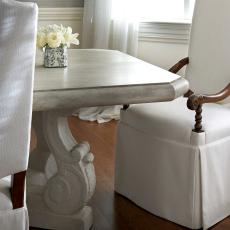 Stone Dining Table Pairs With White Skirted Chairs