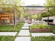 Modern Outdoor Space With Pergola and Raised Herb Planter