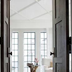 Heavy Wood Doors Open to Clean, Airy Living Room