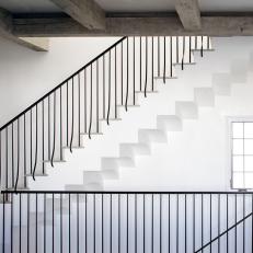 White Stairway With Contemporary Wrought Iron Railing