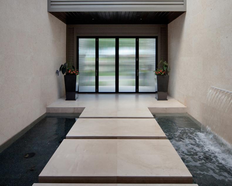 Contemporary Courtyard With Floating Steps Above Moving Water