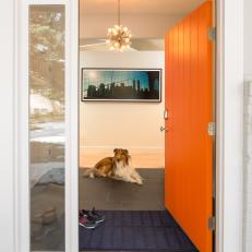 Entry to Modern Home With Bright Orange Front Door