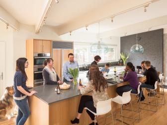 Contemporary White Open Plan Kitchen Filled With People