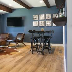 Blue Midcentury Living and Dining Room With Leather Chairs