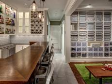 Jeff Pelletier designed a dream basement that features a bar for the adults and a devoted LEGO play area and storage for the kids, creating a shared family room to be enjoyed by all ages.
