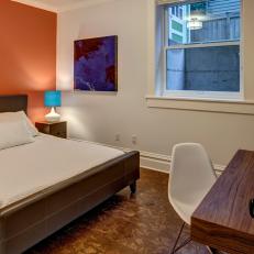 White Basement Bedroom Features Orange Accent Wall