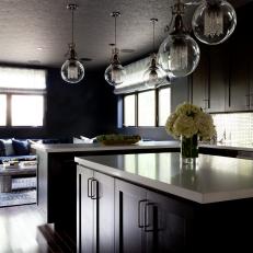 Contemporary Kitchen With Dark Cabinets & Globe Pendants