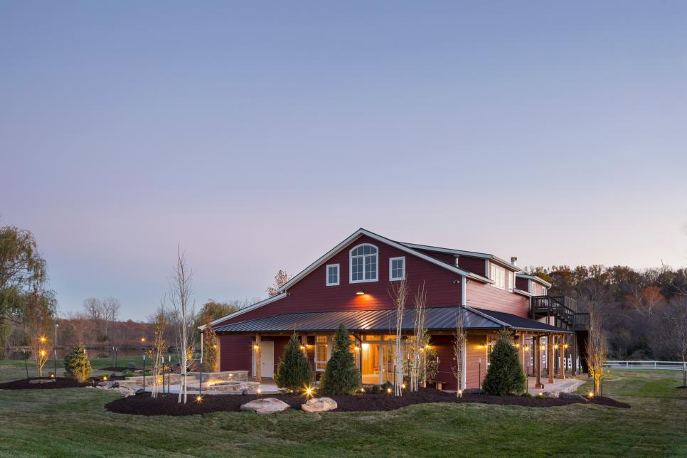 Exterior of Red Party Barn With Landscape Lighting and Mulched Areas