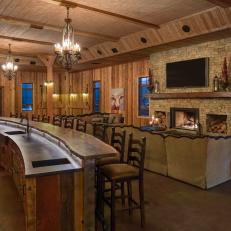 Rustic Great Room With Natural Wood Bar and Stone Fireplace