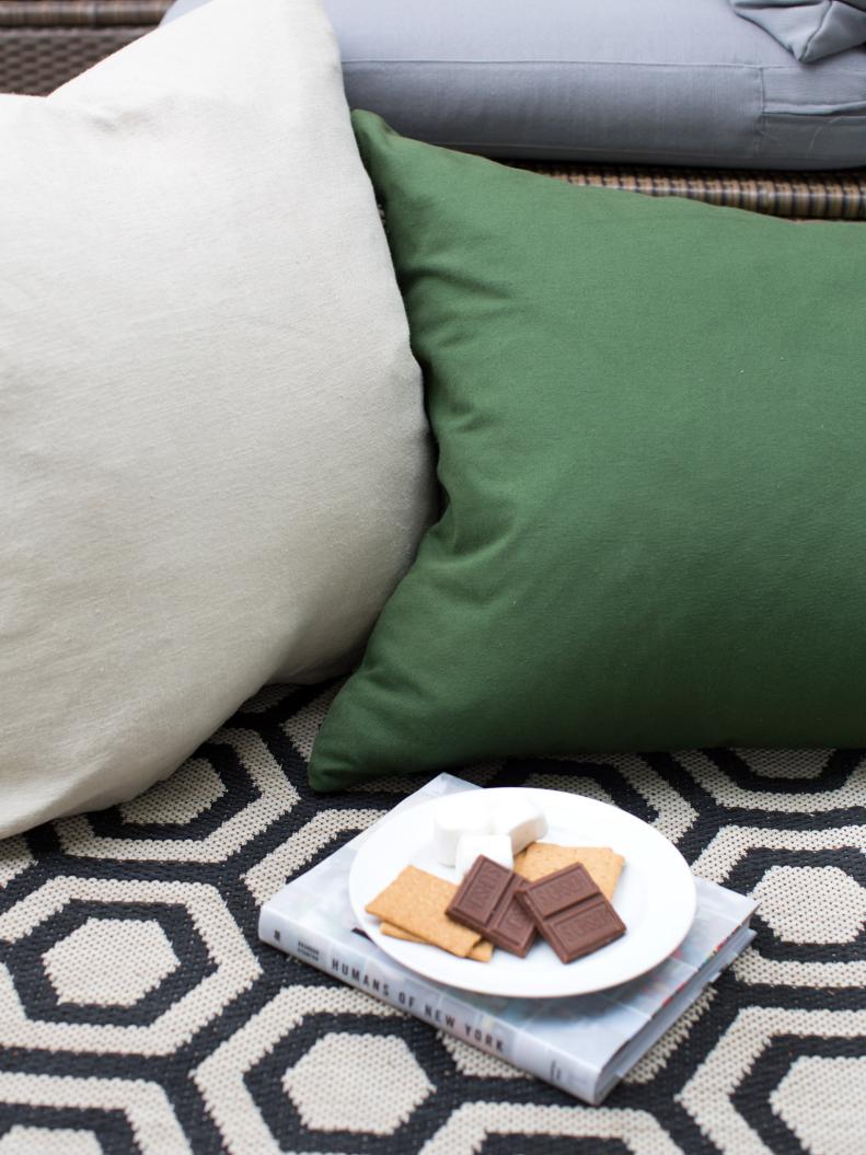 Green and Greige Pillow on Black-and-White Area Rug