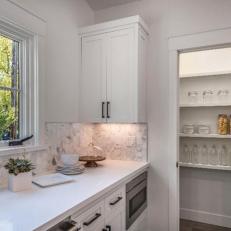 Kitchen Features Clean, Functional White Pantry