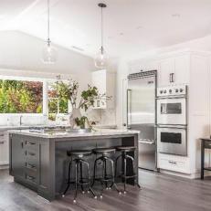 Transitional White Kitchen Features Large Gray Island